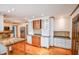 Eat-in kitchen has granite countertops, stainless steel appliances, custom cabinets, and wood flooring at 615 Woodwork Way, Roswell, GA 30076