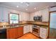 Traditional kitchen featuring granite countertops, stainless steel appliances and wood floors at 615 Woodwork Way, Roswell, GA 30076