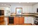 Traditional kitchen with granite countertops, stainless steel appliances and white cabinetry at 615 Woodwork Way, Roswell, GA 30076