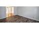 Spacious room featuring hardwood-style flooring and bright lighting at 615 Woodwork Way, Roswell, GA 30076