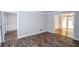Spacious living room with hardwood-style floors and doorways to other rooms at 615 Woodwork Way, Roswell, GA 30076