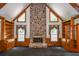 Stately living room showcasing stone fireplace, built-in shelves, and charming windows at 615 Woodwork Way, Roswell, GA 30076