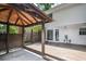 The covered patio offers wood floors, a pergola and access to the main house at 615 Woodwork Way, Roswell, GA 30076