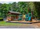 Community playground area with slides, play equipment, and a covered seating area at 615 Woodwork Way, Roswell, GA 30076