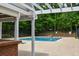 Community pool area with view of the swimming pool, lounge area, and surrounding trees at 615 Woodwork Way, Roswell, GA 30076