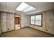 Finished room with panelled walls, carpet floor, one window, and view into a side room at 615 Woodwork Way, Roswell, GA 30076