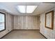 Finished room with panelled walls, carpet floor, a light fixture, and one window at 615 Woodwork Way, Roswell, GA 30076
