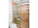 A bathroom featuring a tiled shower with glass doors at 615 Woodwork Way, Roswell, GA 30076