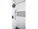 Close-up of a modern shower featuring sleek fixtures and a geometric tile accent wall at 615 Woodwork Way, Roswell, GA 30076
