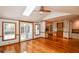 Open sunroom with hardwood floors and access to kitchen and outdoor deck at 615 Woodwork Way, Roswell, GA 30076