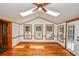 Bright sunroom features wood floors, ceiling fan, windows and doors to deck at 615 Woodwork Way, Roswell, GA 30076