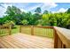 A wooden deck overlooking a lush, green, secluded back yard at 6213 Cherry Ln, Douglasville, GA 30134