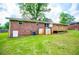 Brick house with a well maintained lawn, wood deck, and storage shed in backyard at 6213 Cherry Ln, Douglasville, GA 30134