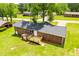 Brick house with a well maintained lawn, wood deck, and storage shed in backyard at 6213 Cherry Ln, Douglasville, GA 30134
