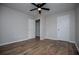 A bedroom featuring hard wood floors and doors to other rooms at 6213 Cherry Ln, Douglasville, GA 30134