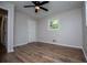 An airy bedroom featuring wood-look floors, ceiling fan, and good natural light at 6213 Cherry Ln, Douglasville, GA 30134