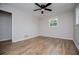 Simple bedroom with wood flooring, ceiling fan and lots of natural light at 6213 Cherry Ln, Douglasville, GA 30134
