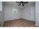 A well-lit bedroom featuring wood-look floors and ceiling fan at 6213 Cherry Ln, Douglasville, GA 30134