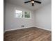 Neutral bedroom with wood flooring, ceiling fan and lots of natural light at 6213 Cherry Ln, Douglasville, GA 30134