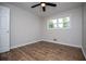 Neutral bedroom with wood flooring, ceiling fan and lots of natural light at 6213 Cherry Ln, Douglasville, GA 30134