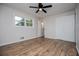 Neutral bedroom with wood flooring, closet, ceiling fan, and lots of natural light at 6213 Cherry Ln, Douglasville, GA 30134