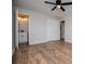 Bright bedroom with wood flooring, ceiling fan, and attached bath at 6213 Cherry Ln, Douglasville, GA 30134