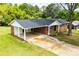 Charming home featuring brick exterior, covered carport, and a long driveway at 6213 Cherry Ln, Douglasville, GA 30134
