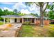 Charming brick ranch with black shutters, a covered carport and beautiful landscaping at 6213 Cherry Ln, Douglasville, GA 30134