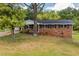A brick ranch house with black shutters and a carport covered in white siding at 6213 Cherry Ln, Douglasville, GA 30134