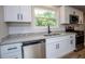 Updated kitchen features white cabinets, granite countertops, and stainless steel appliances at 6213 Cherry Ln, Douglasville, GA 30134