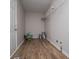 Spacious laundry room featuring wood flooring and shelving at 6213 Cherry Ln, Douglasville, GA 30134