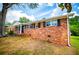 A view of the side of a brick home with black shutters on the windows at 6213 Cherry Ln, Douglasville, GA 30134