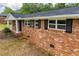 View of the side of a brick home with white trim and black shutters at 6213 Cherry Ln, Douglasville, GA 30134