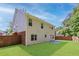 Backyard with green lawn, partial wood fence and concrete patio on a beautiful sunny day at 4353 Pond Edge Rd, Snellville, GA 30039