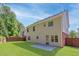 Backyard with green lawn, partial wood fence and concrete patio on a beautiful sunny day at 4353 Pond Edge Rd, Snellville, GA 30039