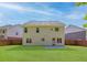 Backyard with green lawn, partial wood fence and concrete patio on a beautiful sunny day at 4353 Pond Edge Rd, Snellville, GA 30039