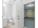 Half bathroom that has an open door to a garage with epoxy flooring at 4353 Pond Edge Rd, Snellville, GA 30039