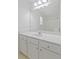 Bathroom with white quartz counters, sink, ample cabinet space, large mirror and modern lighting at 4353 Pond Edge Rd, Snellville, GA 30039