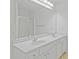 Bathroom with double vanity, white cabinets, white countertops, and large mirror at 4353 Pond Edge Rd, Snellville, GA 30039