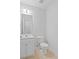 Half bathroom with tiled floors, white vanity, and modern fixtures at 4353 Pond Edge Rd, Snellville, GA 30039