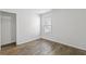 Bedroom featuring hardwood floors, closet, and window with lots of natural light at 4353 Pond Edge Rd, Snellville, GA 30039