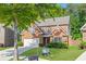 Beautiful brick home with an attached two-car garage, well-kept lawn, and a mature tree gracing the front yard at 4353 Pond Edge Rd, Snellville, GA 30039