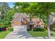 Charming brick home with a well-manicured lawn, two-car garage, and mature trees in a Gathering-friendly neighborhood at 4353 Pond Edge Rd, Snellville, GA 30039