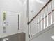 Bright foyer featuring white walls, a staircase with wooden railing, and a front door with sidelights at 4353 Pond Edge Rd, Snellville, GA 30039