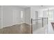 Open hallway featuring hardwood floors, white trim, and modern lighting at 4353 Pond Edge Rd, Snellville, GA 30039