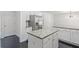 Open kitchen with granite countertops, stainless steel refrigerator, and an island with storage at 4353 Pond Edge Rd, Snellville, GA 30039