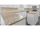 Kitchen featuring granite countertops, white cabinets, and stainless steel appliances at 4353 Pond Edge Rd, Snellville, GA 30039