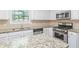 Kitchen with granite countertops, stainless steel appliances, and ample counter space at 4353 Pond Edge Rd, Snellville, GA 30039