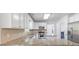 Well-lit kitchen featuring stainless steel appliances, granite countertops, and white cabinetry at 4353 Pond Edge Rd, Snellville, GA 30039