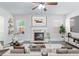 Bright living room with fireplace, ceiling fan, neutral decor, and ample natural light at 4353 Pond Edge Rd, Snellville, GA 30039